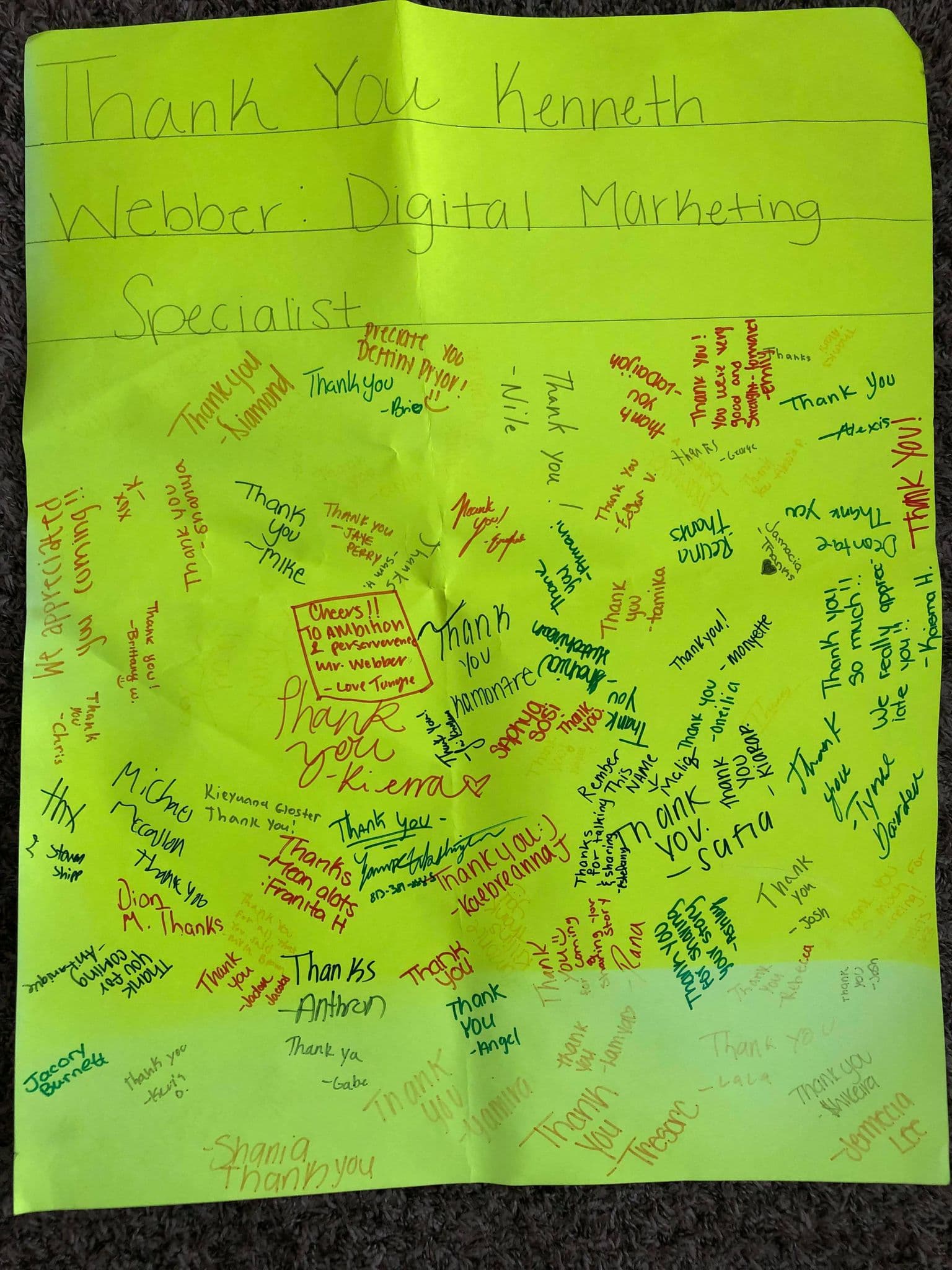 Signed thank-you board presented to Kenneth by high-school students